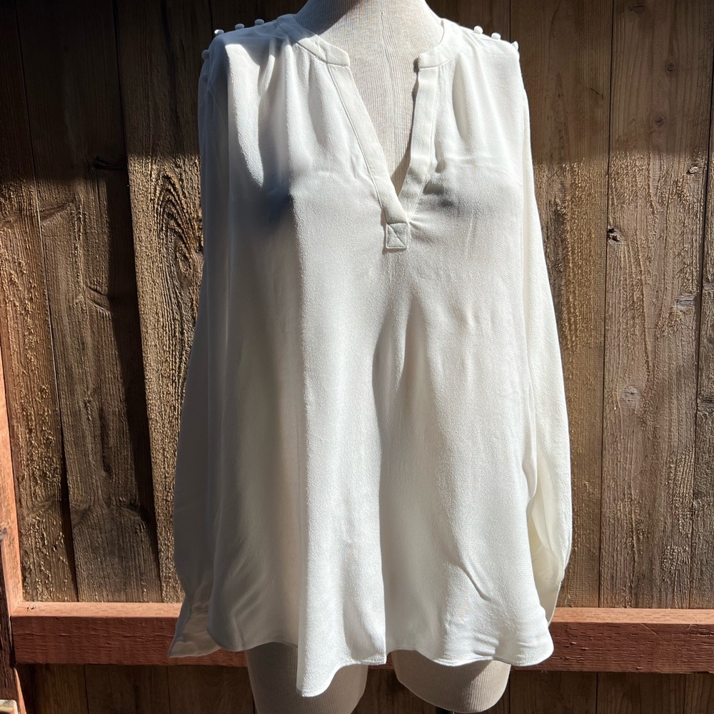 Long sleeve blouse with button detail from shoulder to cuffs. Size L.